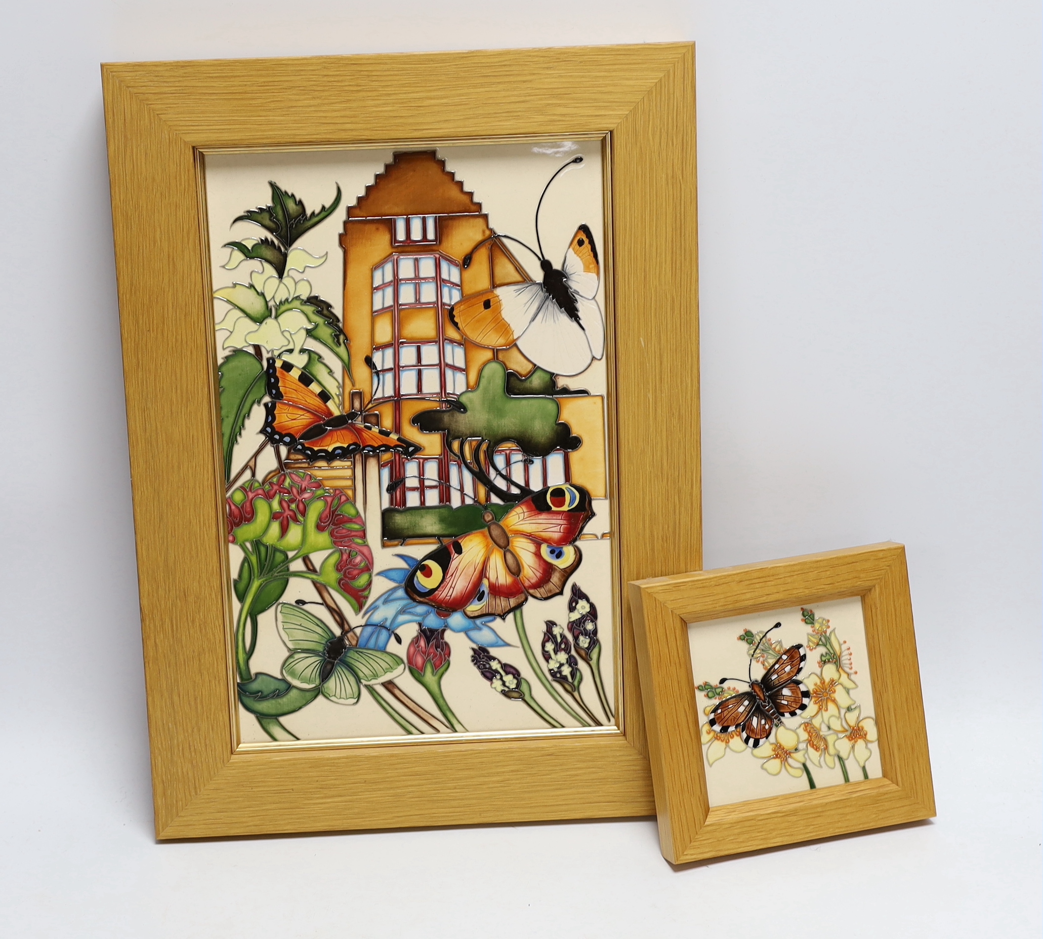 A Moorcroft Rachel Bishop wall plaque of butterflies and a similar smaller plaque, both in oak frames, largest 38 x 28cm